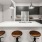 a kitchen with a bar stool and a table
