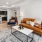 a living room with a couch and a dining table