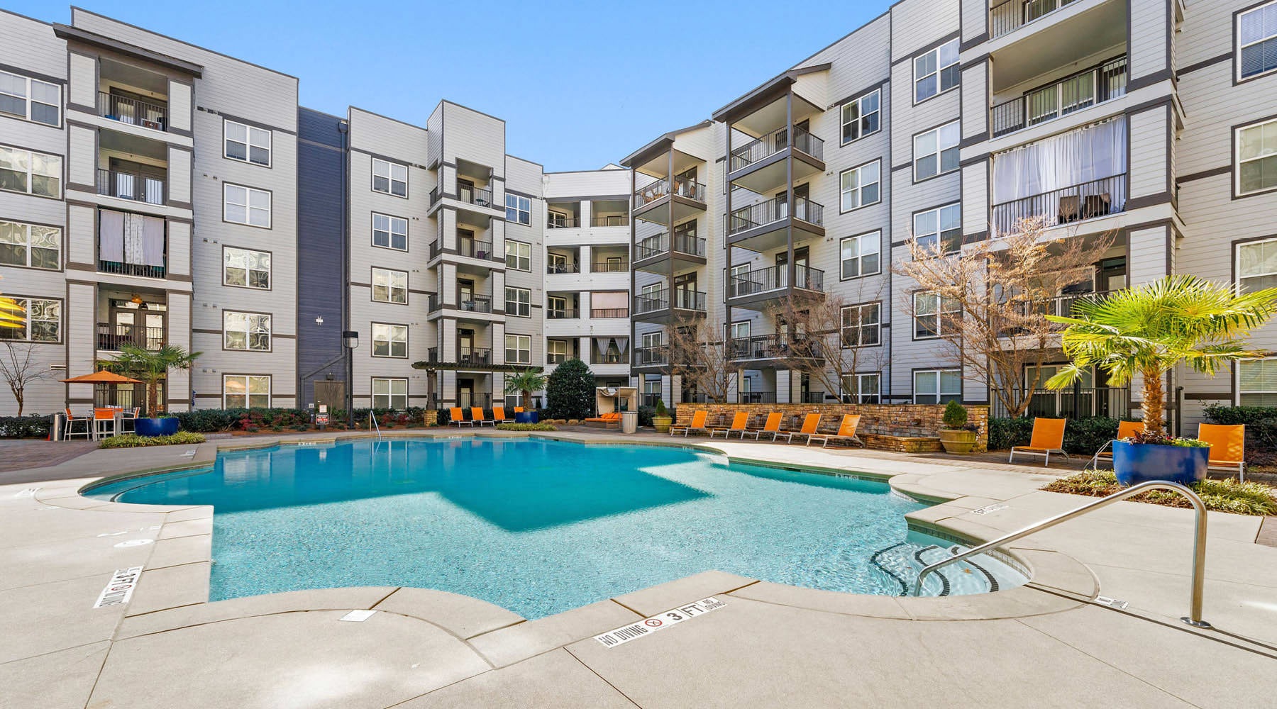 Settle into comfort at The Lookout O4W a pool in a courtyard between buildings